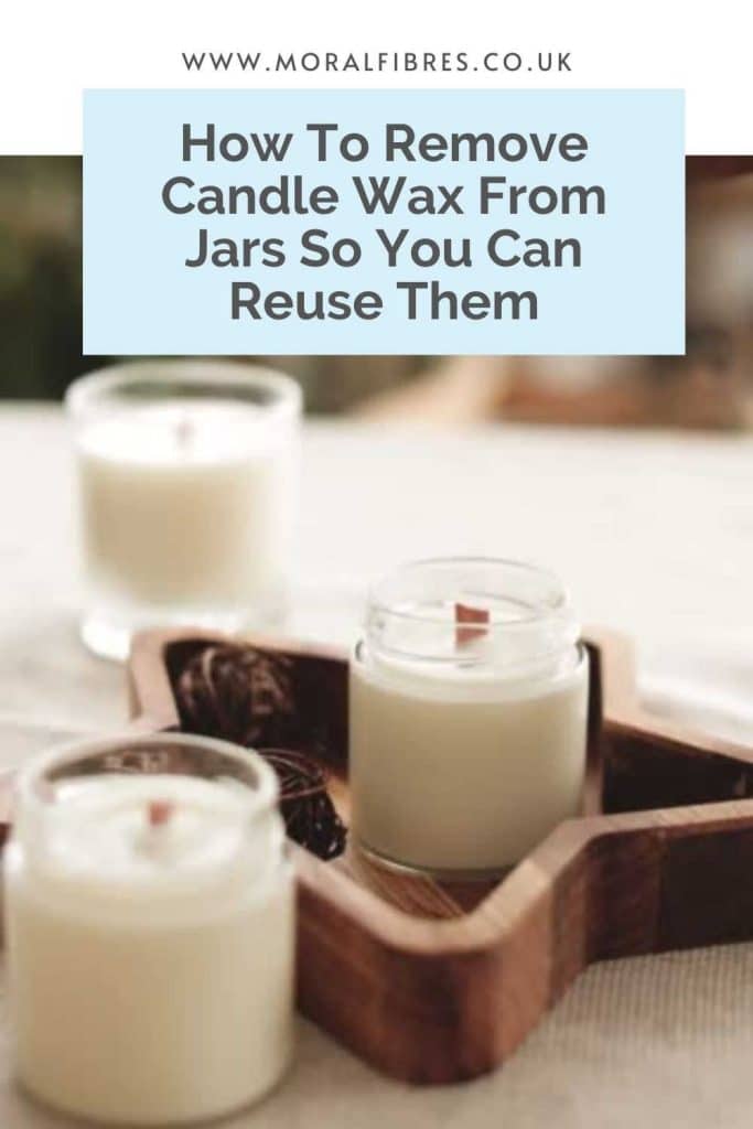 Image of three candles in glass jars with a blue text box that says how to remove candle wax from jars so you can reuse them.