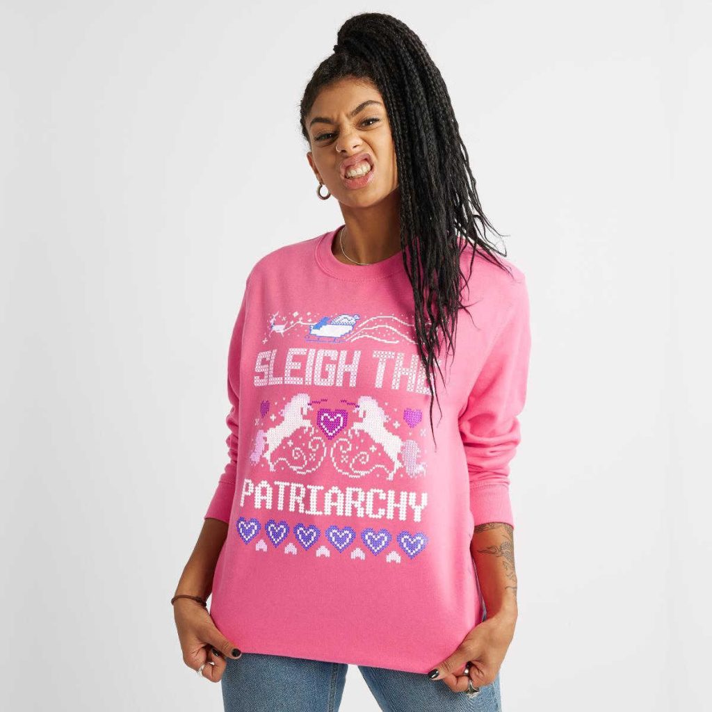 Person wearing The Spark Company's sleigh the patriarchy jumper.