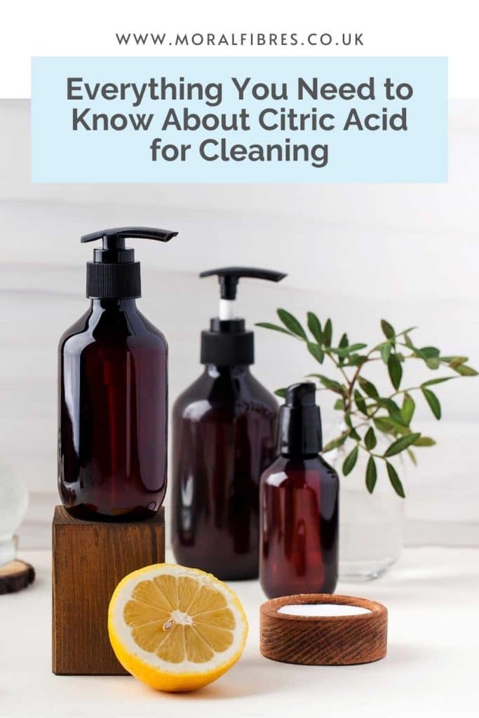 Image of amber glass bottles and a lemon with a blue text box that says everything you need to know about citric acid for cleaning