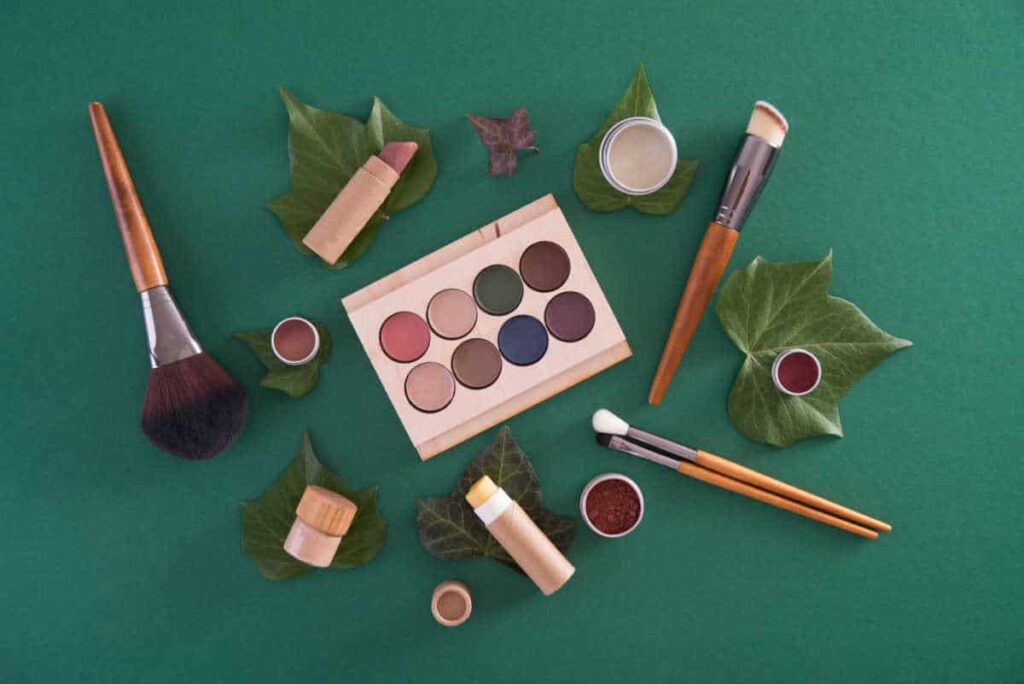 selection of plastic-free makeup items on green background
