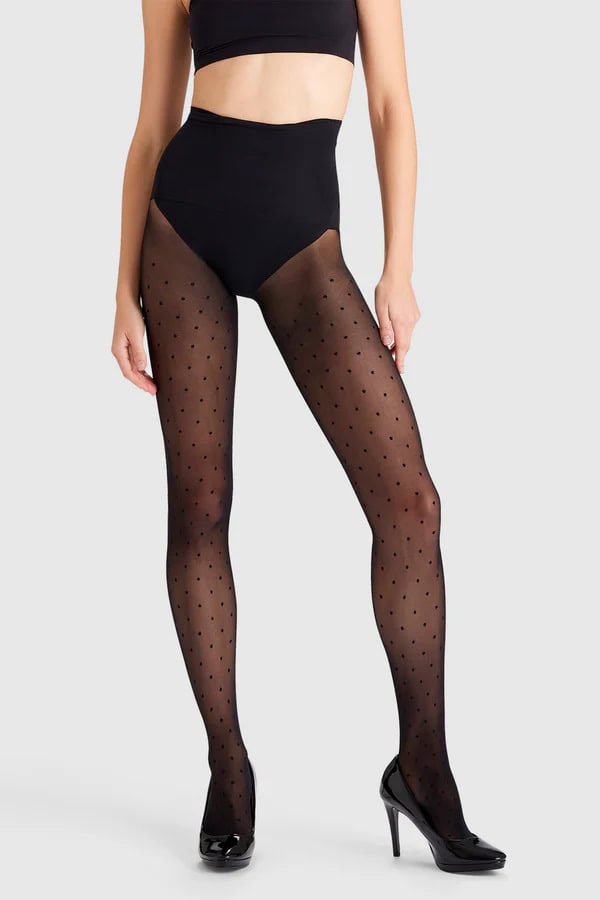 Person wearing black spotty tights from Heist.