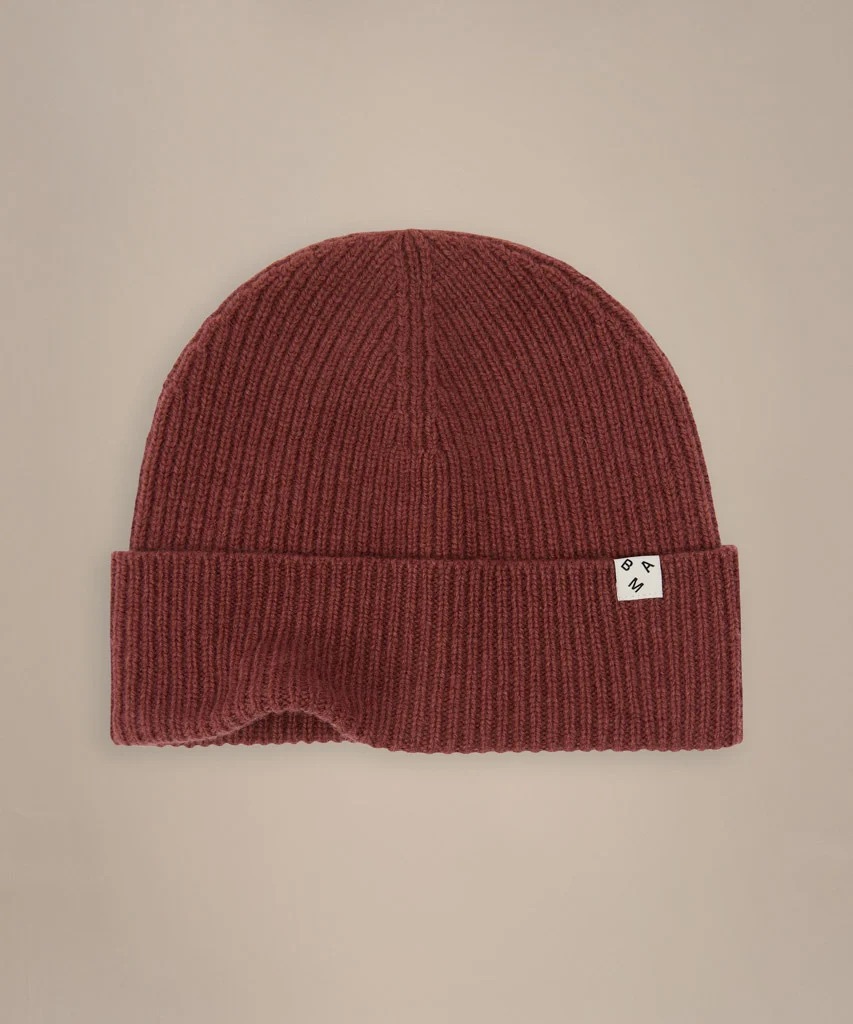 Burgundy wool BAM hat laid flat on a beige background