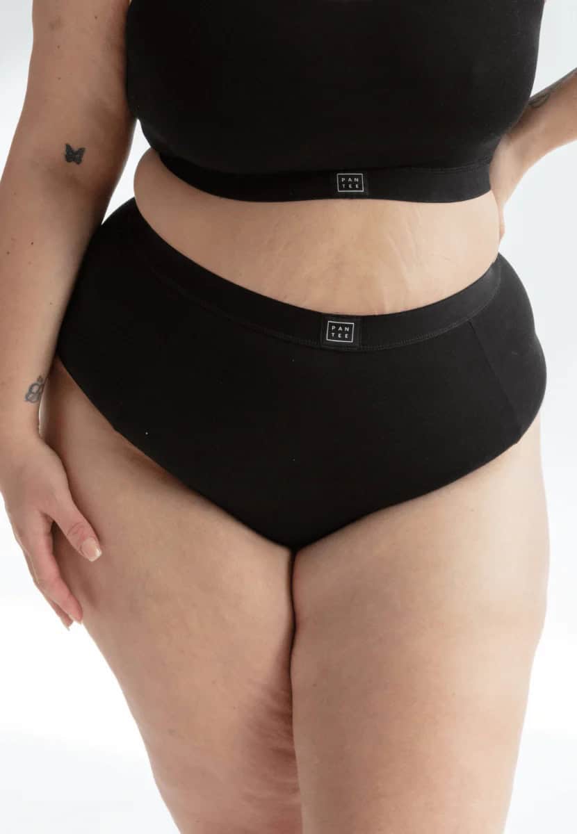 Person wearing a black bra and matching briefs from plus-size friendly sustainable and ethical brand Not Basics