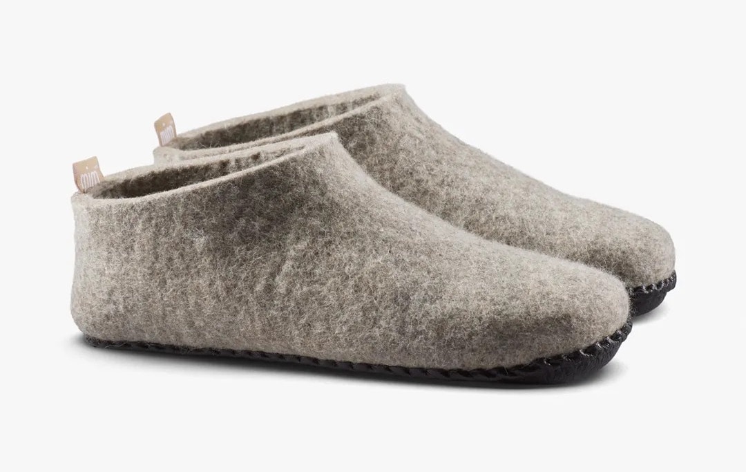 Grey plastic-free slippers from Vivobarefoot on a white background.