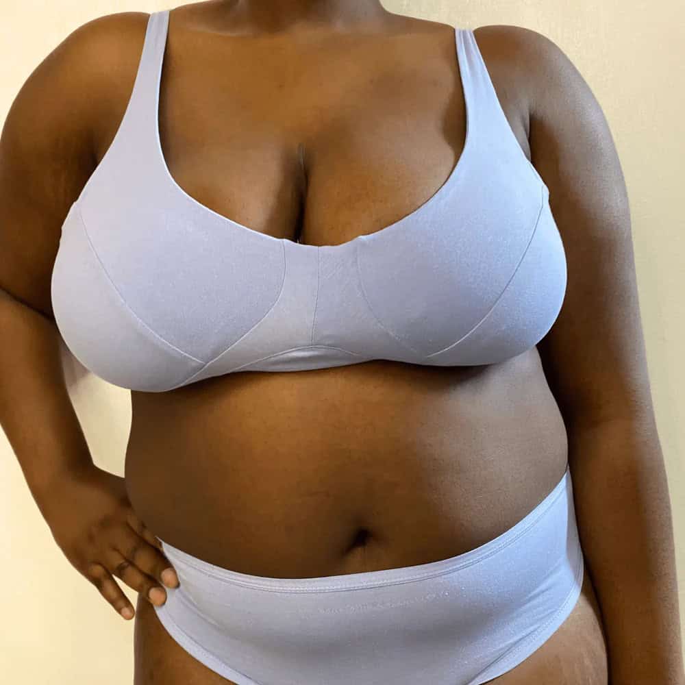 Person in a blue bra and pants from sustainable underwear brand Y.O.U.